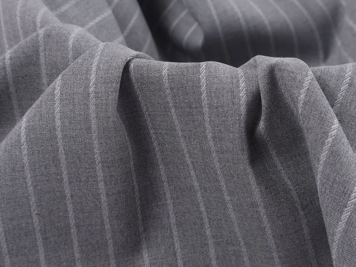 Grey pinstriped suiting fabric draped over a surface